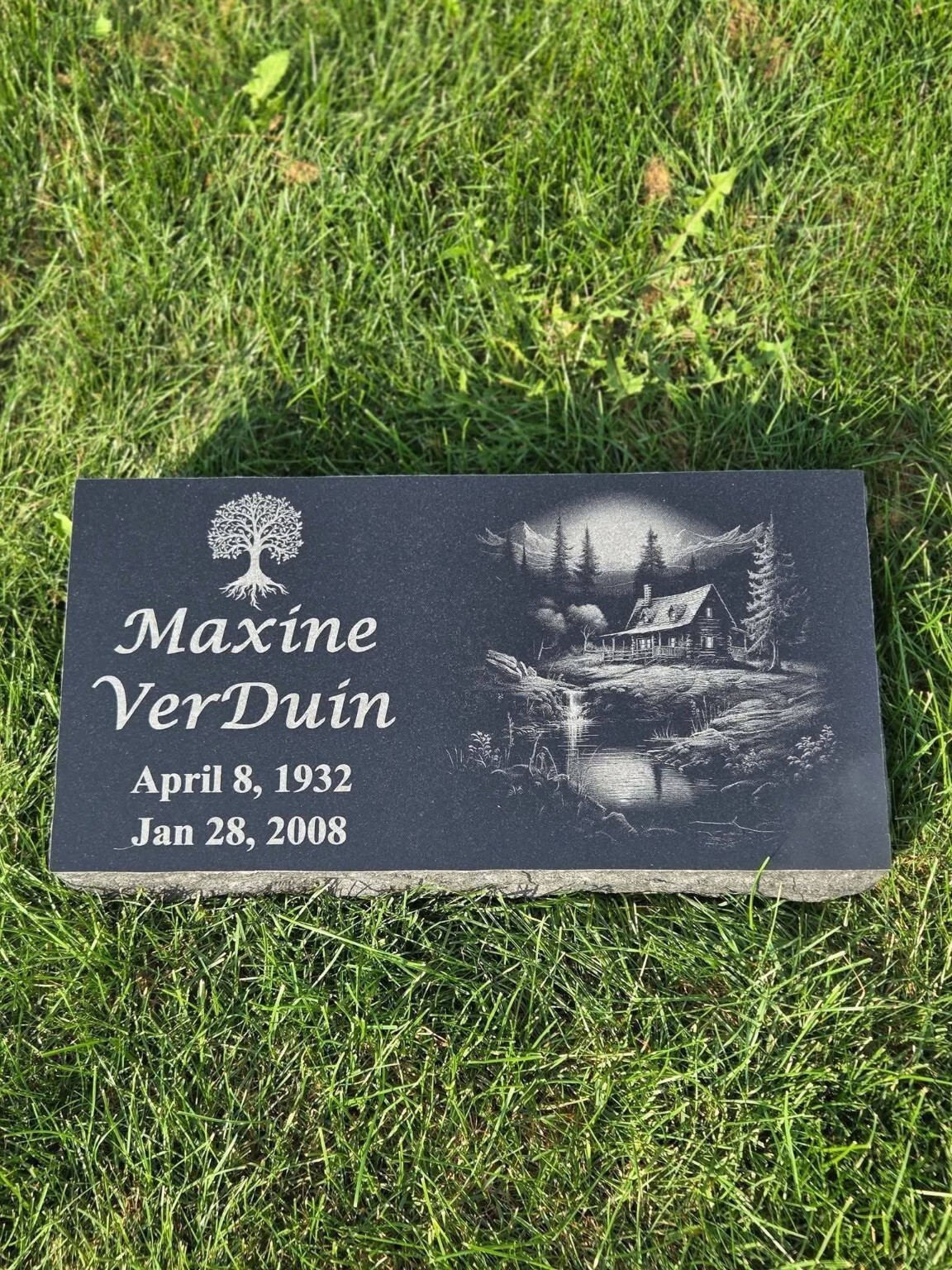 Jet Black granite flat memorial marker with a laser-etched portrait and inscription